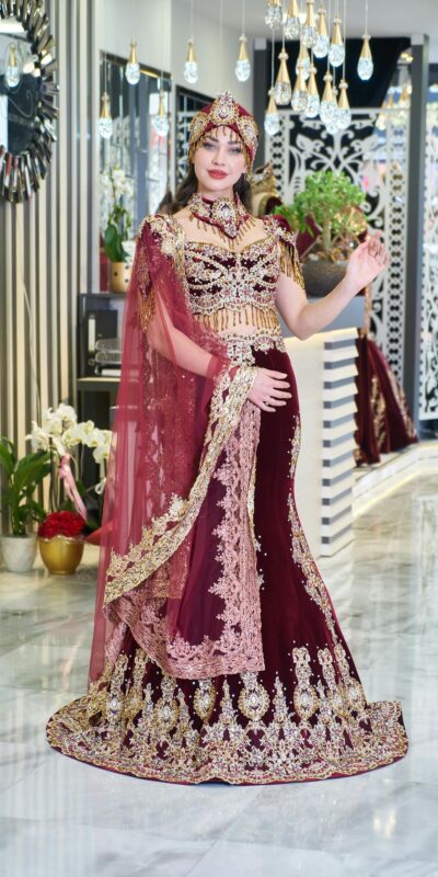 A bride elegantly poses in a luxurious traditional kaftan inside a chic fashion boutique.