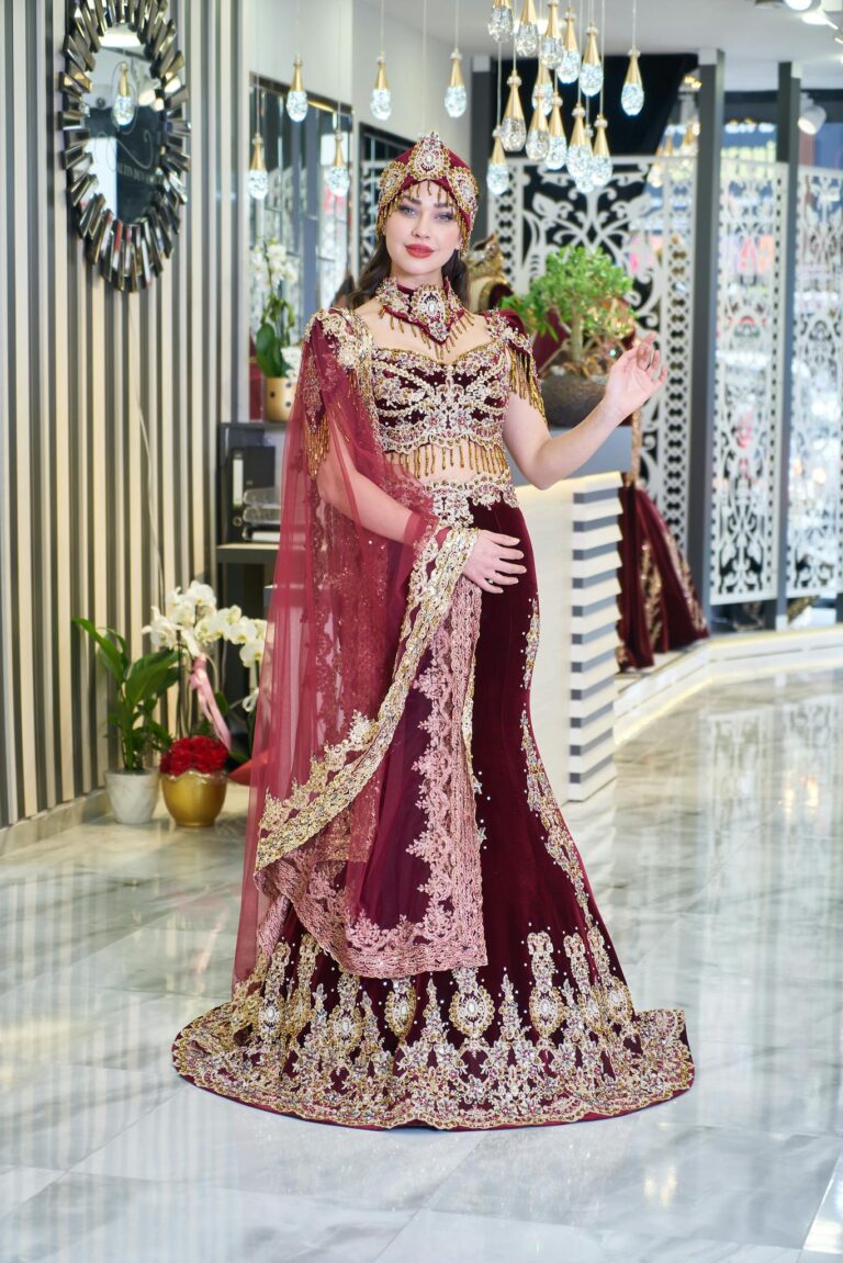 A bride elegantly poses in a luxurious traditional kaftan inside a chic fashion boutique.