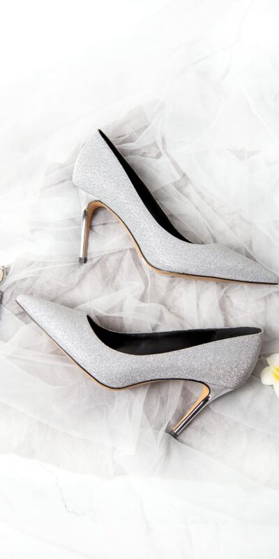 Chic and stylish silver high heels paired with elegant earrings, perfect for formal wear.
